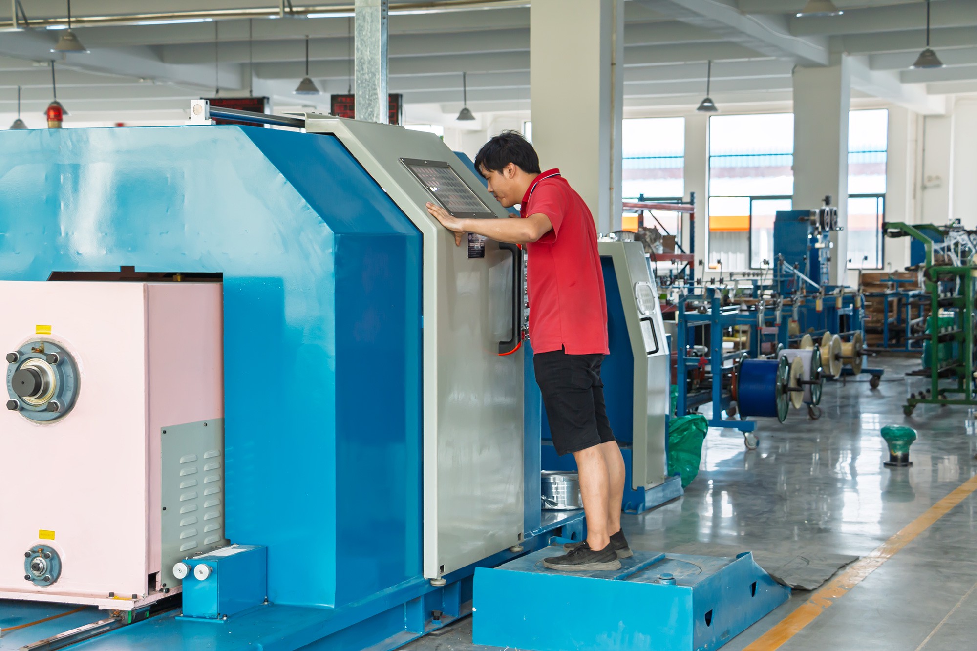 Operator Adjusting Stranding Machine