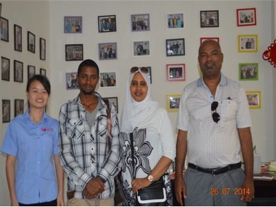 Customers pose for a photo at Yangbang Machinery's office.