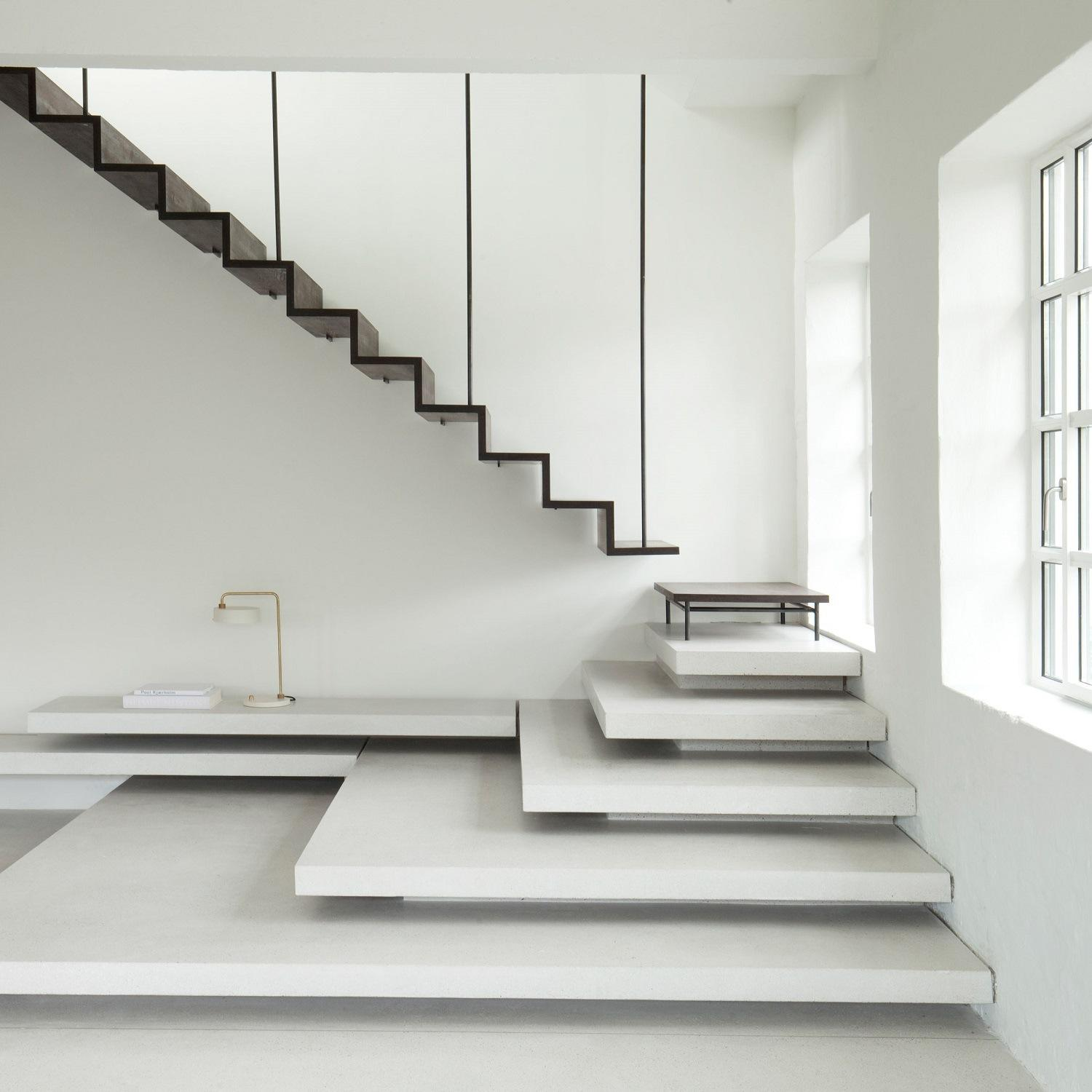 Floating cantilever staircase structure with wooden steps supporting the building