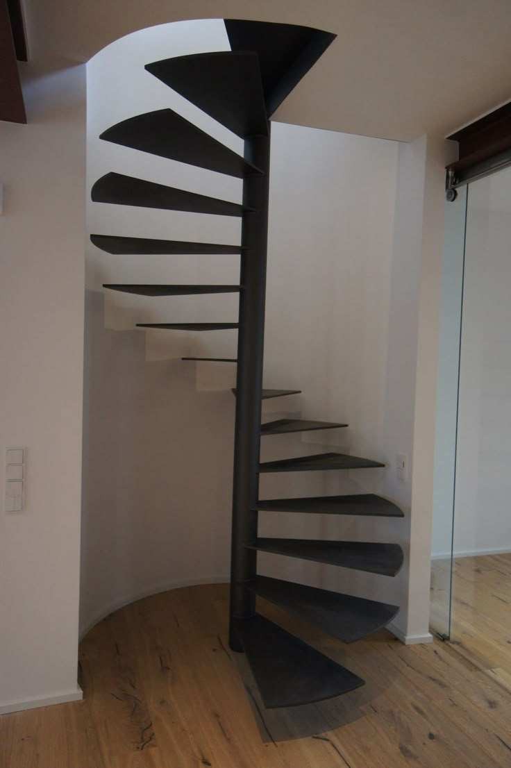 Floating heavy-duty spiral staircase with glass railing, traditional steel wood structure indoors