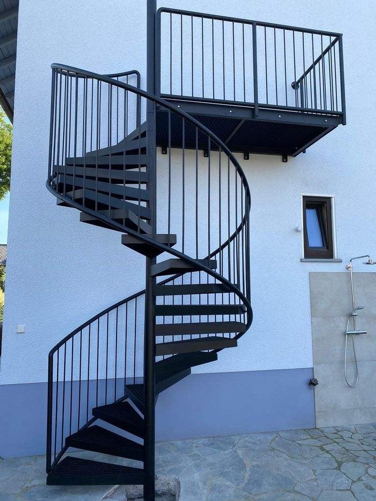 Floating heavy-duty spiral staircase with glass railing, traditional steel wood structure indoors