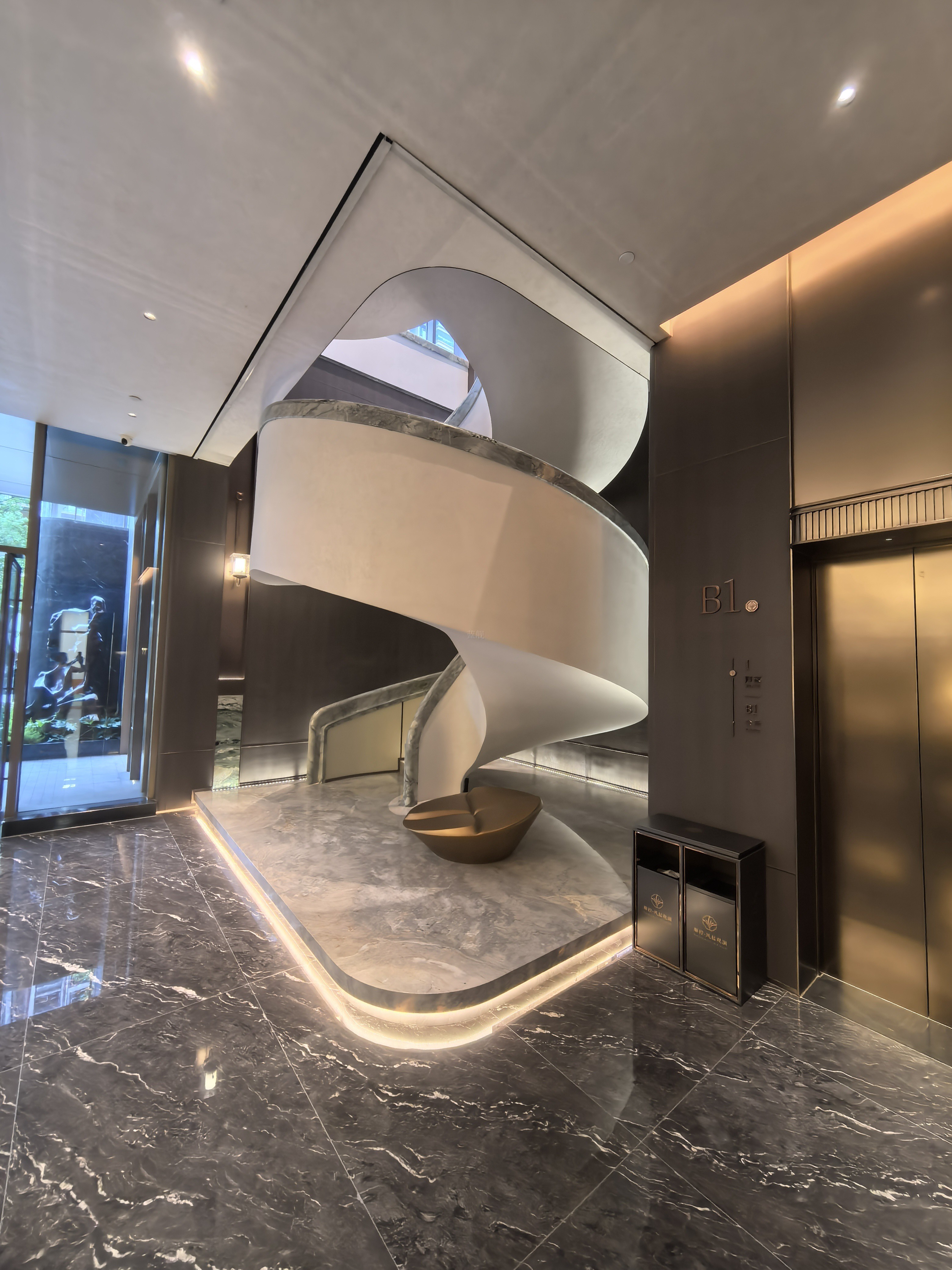 White helical staircase centerpiece in sales gallery