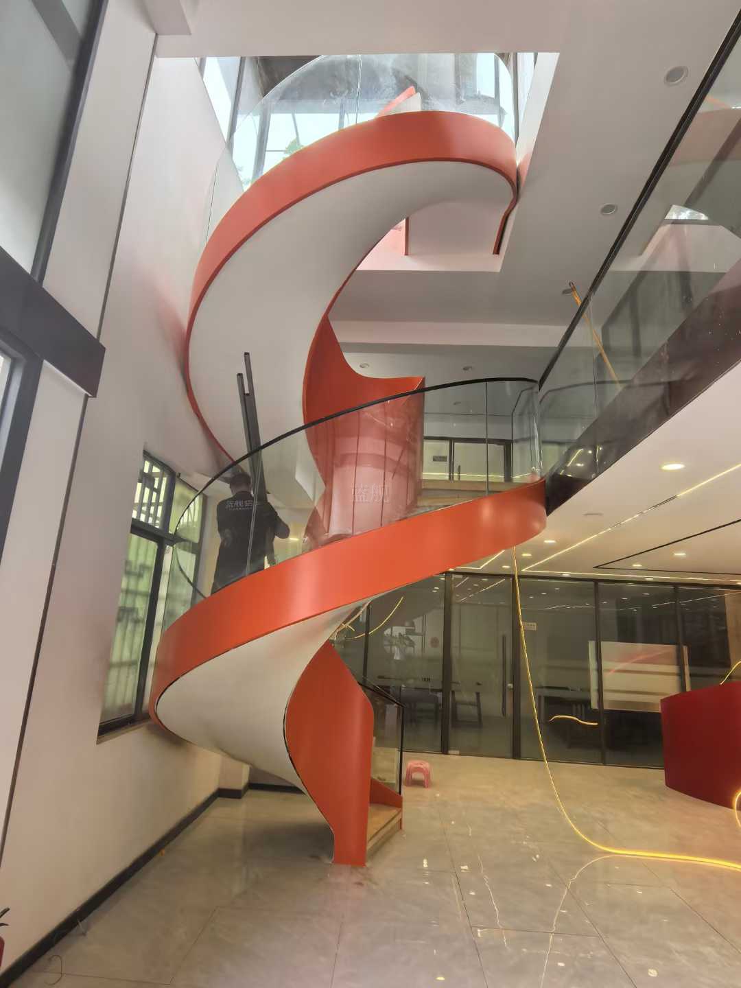 Two-tone white and red sculptural helical staircase