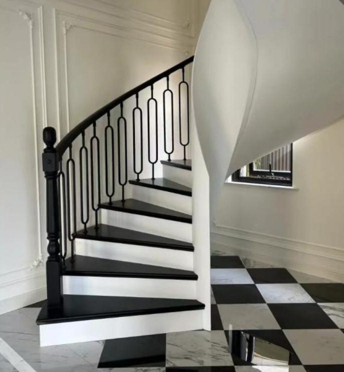 Classic White Curved Staircase with Wrought Iron Railing
