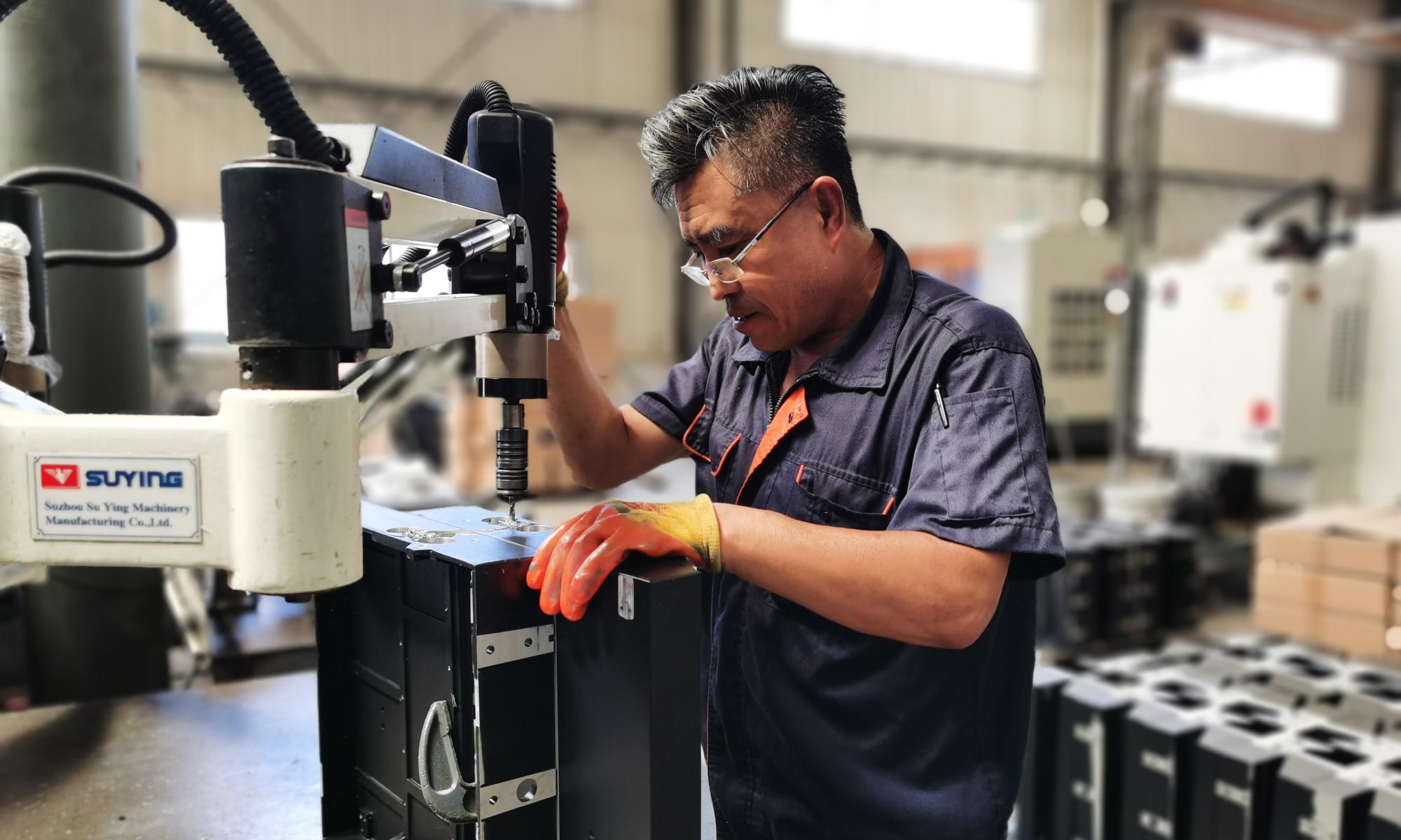Workers operating the machinery