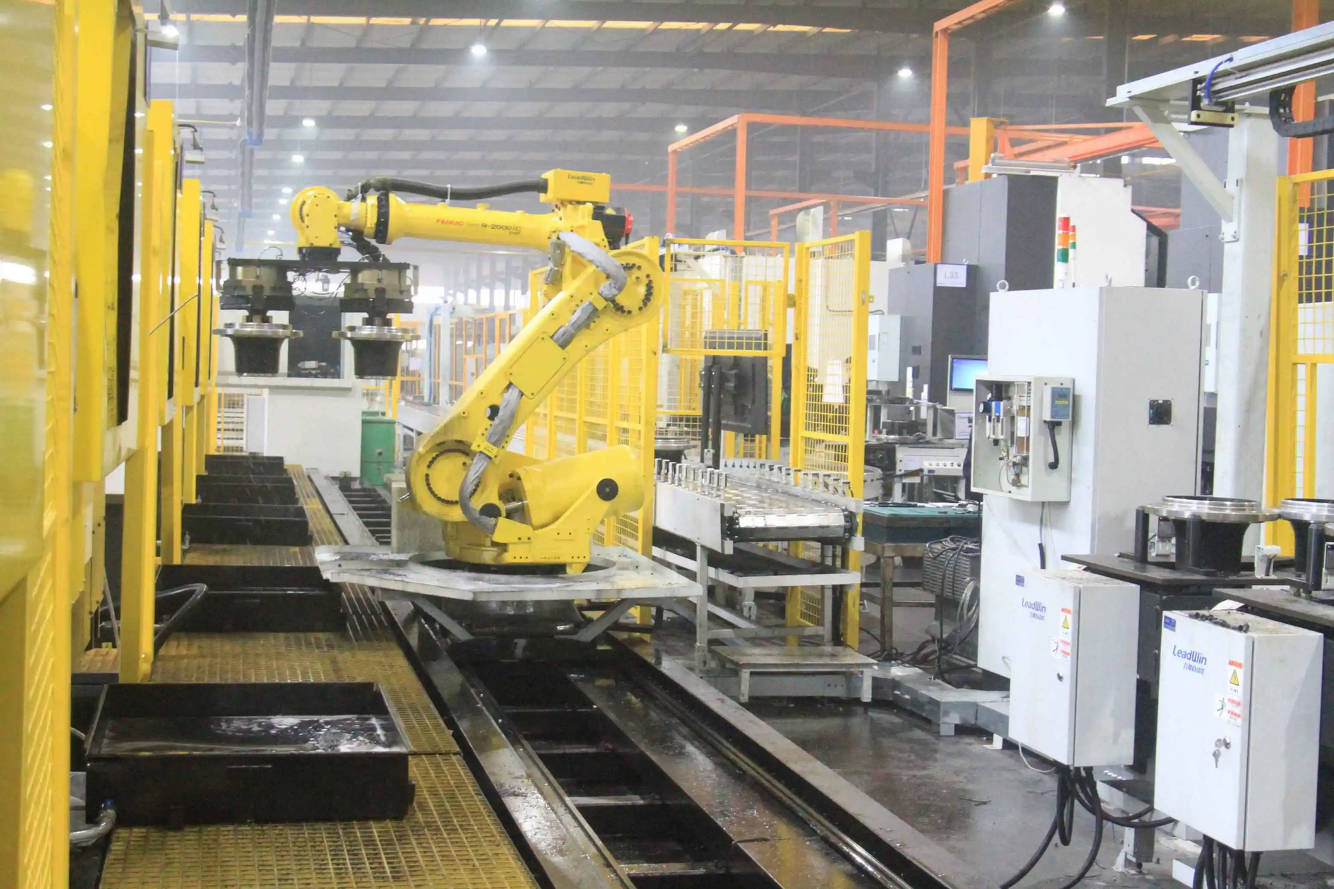 FANUC robots do parts handling and palletizing