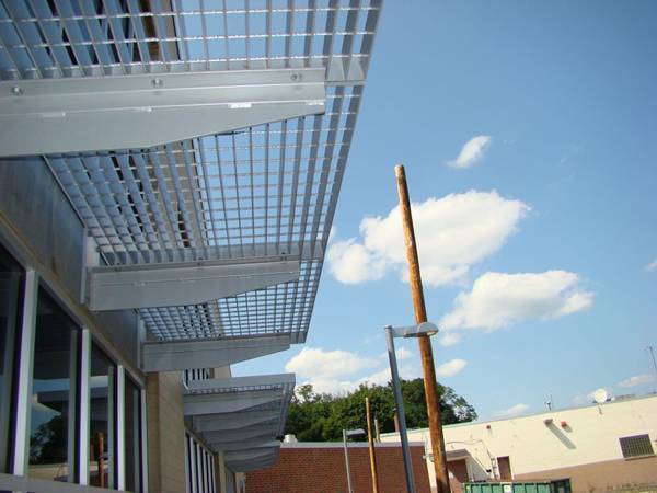 Aluminum gratings serve as sun shades against the blue sky..jpg