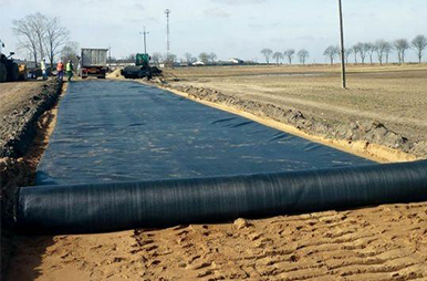 What are the advantages of composite drainage networks in road construction?