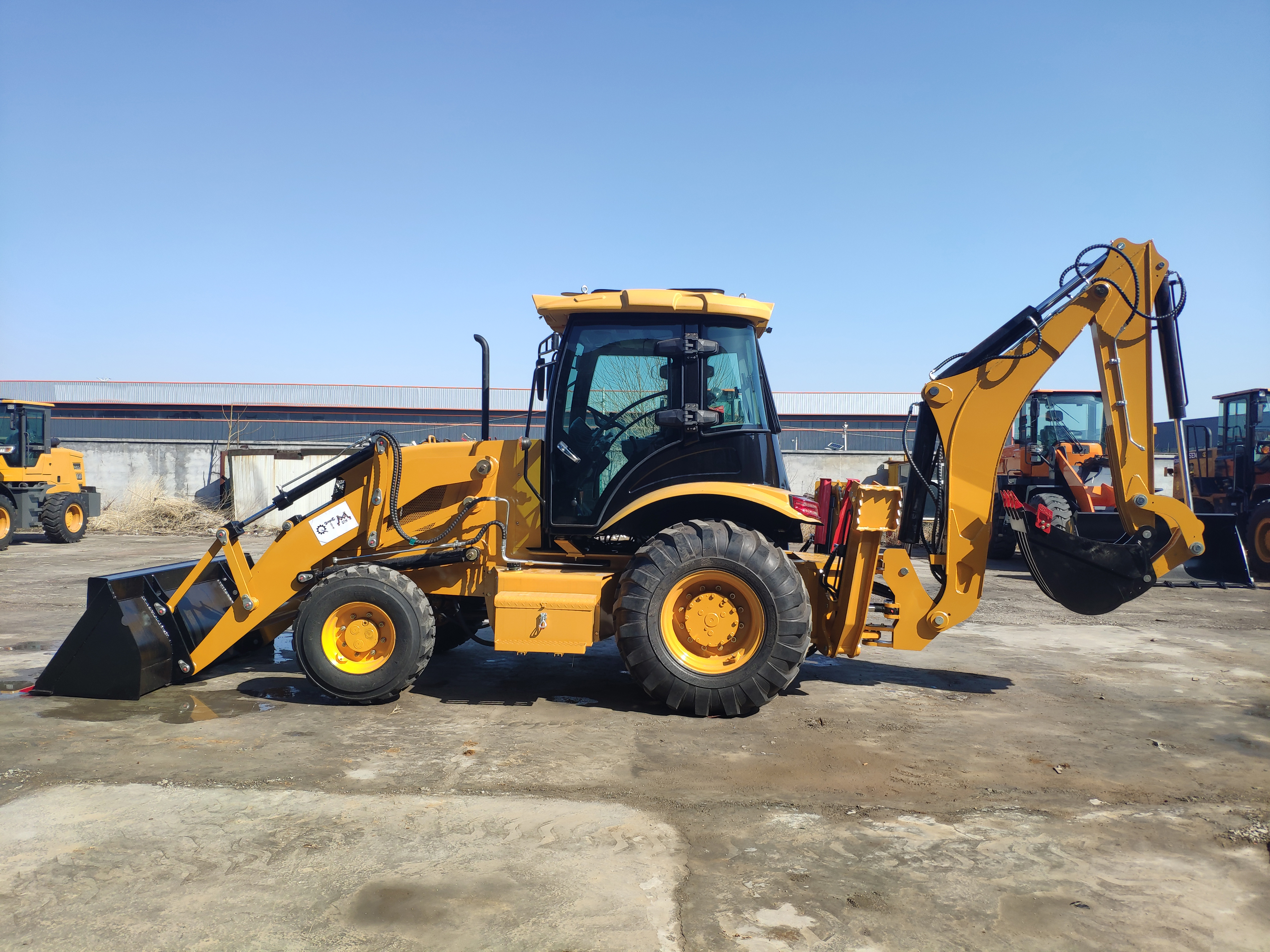 New backhoe loader is rolled off the assembly line