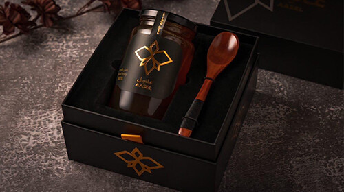 black honey paper box with gold foil logo and foam insert