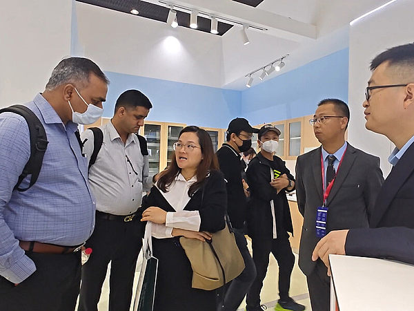 International buyers learn about product details at the VOUPLUS booth at the Guangzhou International Furniture Fair