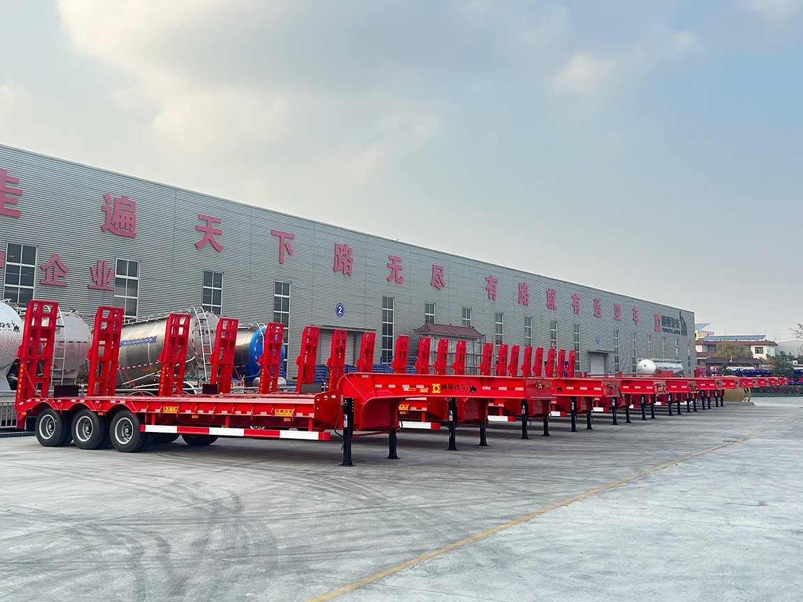 A large number of Low Bed Semi-trailers ready to be shipped to overseas.png