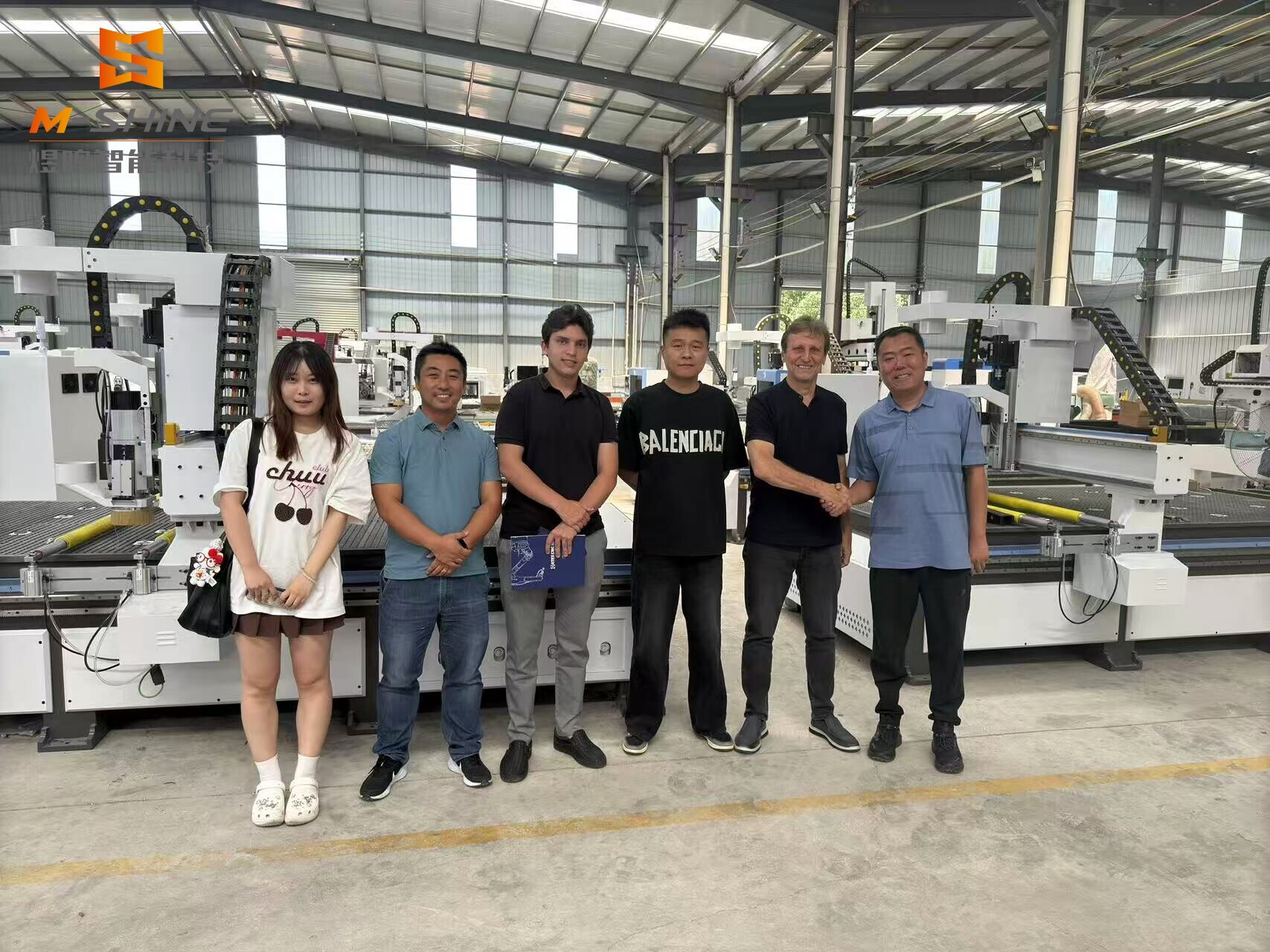 A delegation from a well-known furniture company in Brazil inspects JINAN M-SHINE Woodworking ATC Nesting CNC Router Auto Labeling Line