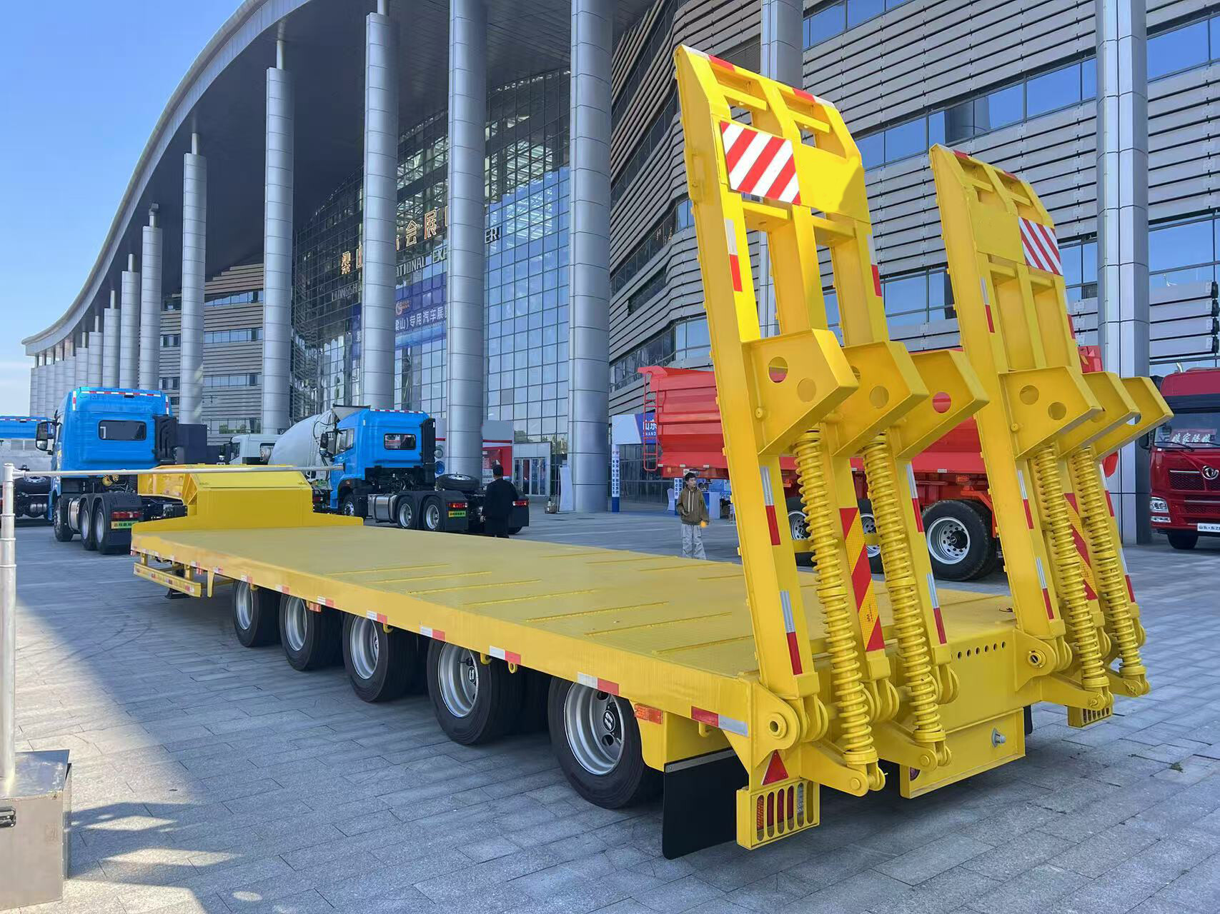 How is the flat bed trailer transported in a container