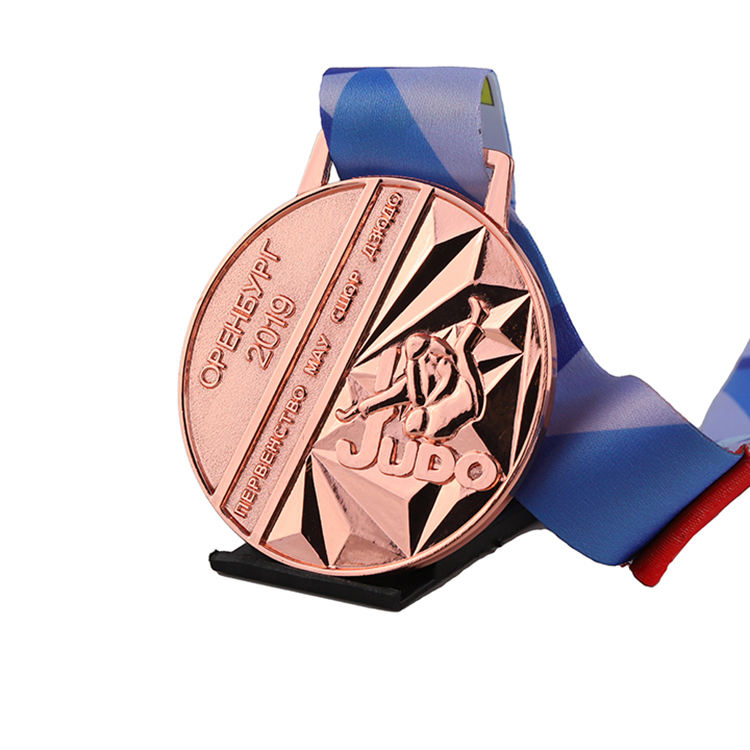 3D gold, silver, and bronze engraved personalized medals for judo, kung fu, karate, and taekwondo, with ribbons.