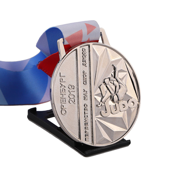 3D gold, silver, and bronze engraved personalized medals for judo, kung fu, karate, and taekwondo, with ribbons.