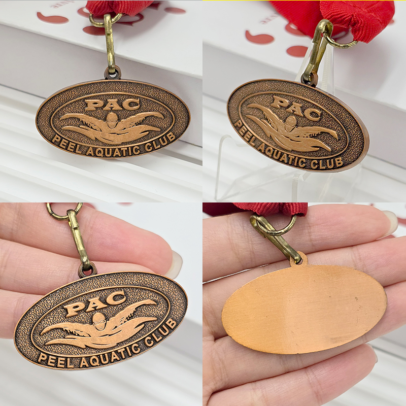 Retro bronze oval metal medal, swimming-themed relief from a water sports club, collectible ornament for water sports events.