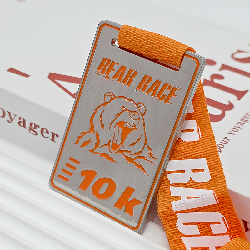 Silver and orange color-blocked metallic medal, commemorative bear head relief for outdoor running events, collectible ornament.