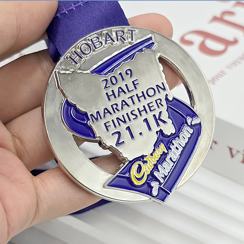 Metal medal, Hobart Half Marathon commemorative city silhouette relief, Cadbury sponsored event collectible.