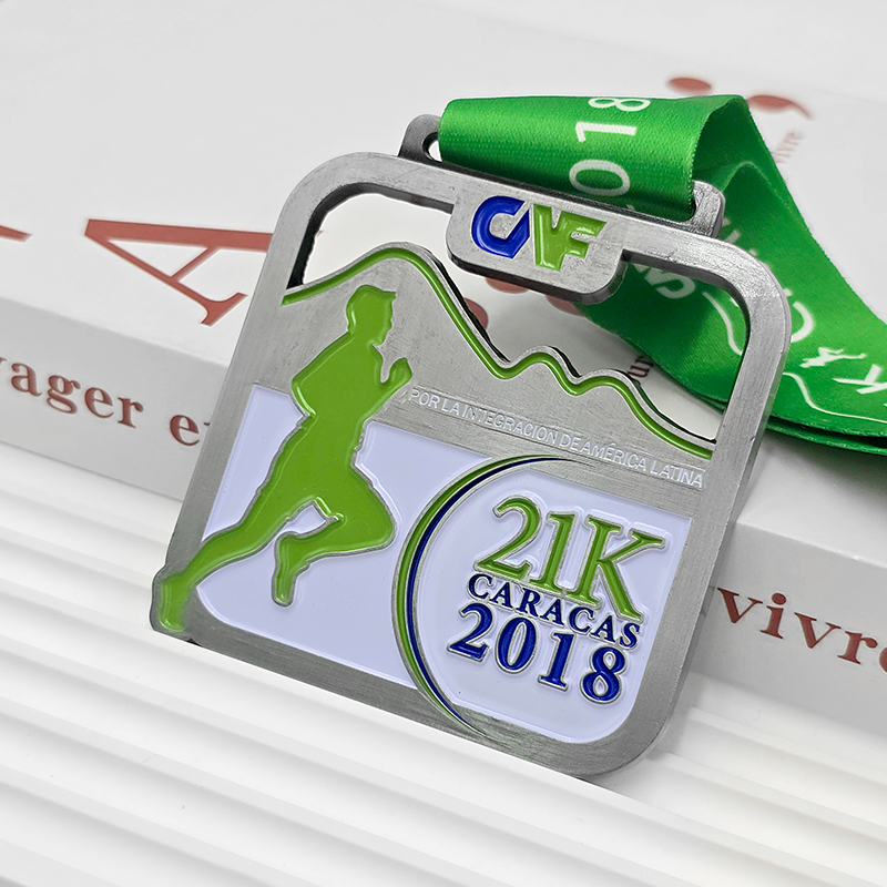 Silver and green color-blocked metallic medal, 21K half marathon commemorative runner silhouette relief, Latin American integration-themed race collectible.