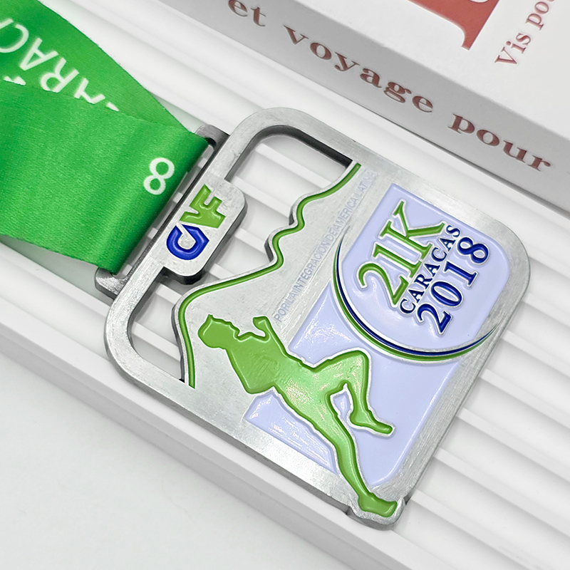 Silver and green color-blocked metallic medal, 21K half marathon commemorative runner silhouette relief, Latin American integration-themed race collectible.