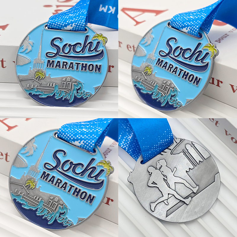 Silver and blue color-blocked metallic medal, Sochi Marathon commemorative city architecture wave relief, seaside race collectible.