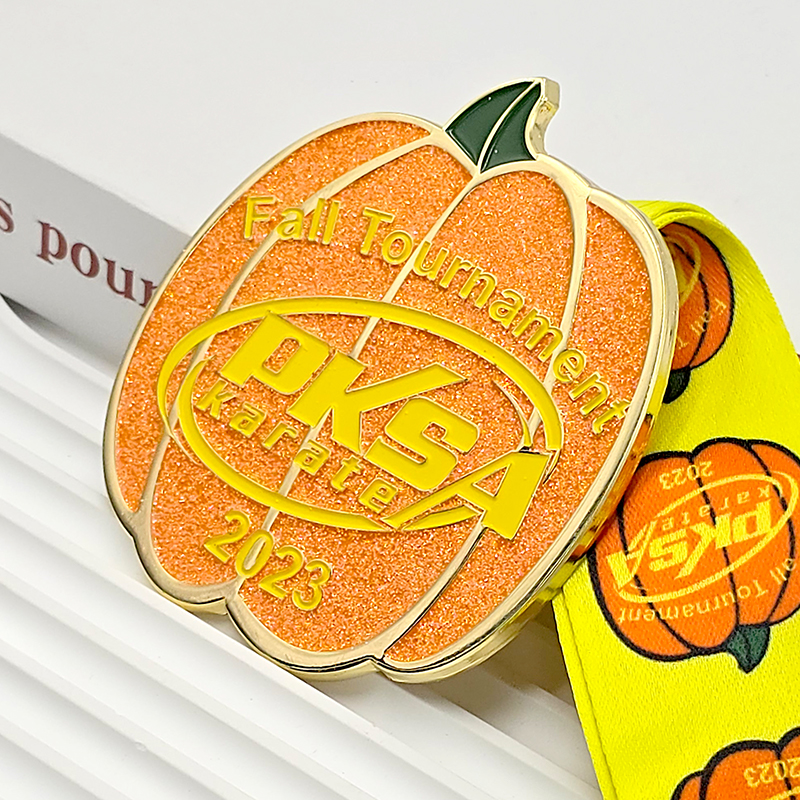 Orange and gold color-blocked pumpkin-shaped metal medal, commemorating the 2023 PKSA Karate Autumn Championships, Halloween-themed collectible item.