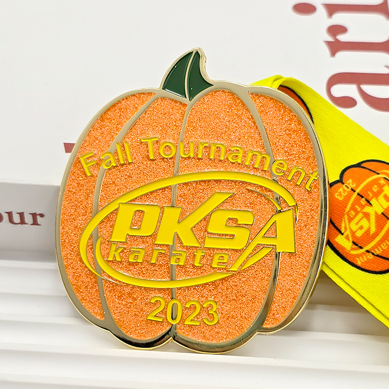 Orange and gold color-blocked pumpkin-shaped metal medal, commemorating the 2023 PKSA Karate Autumn Championships, Halloween-themed collectible item.