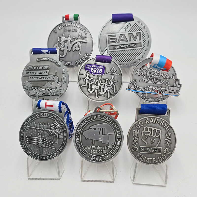 Silver multi-themed event medal set: Commemorative items from the Russian Marathon, Australian Rowing Championships, Karate Open, Model Airplane Championships, etc.; City/Sports reliefs; Collectible set of niche events from multiple countries.