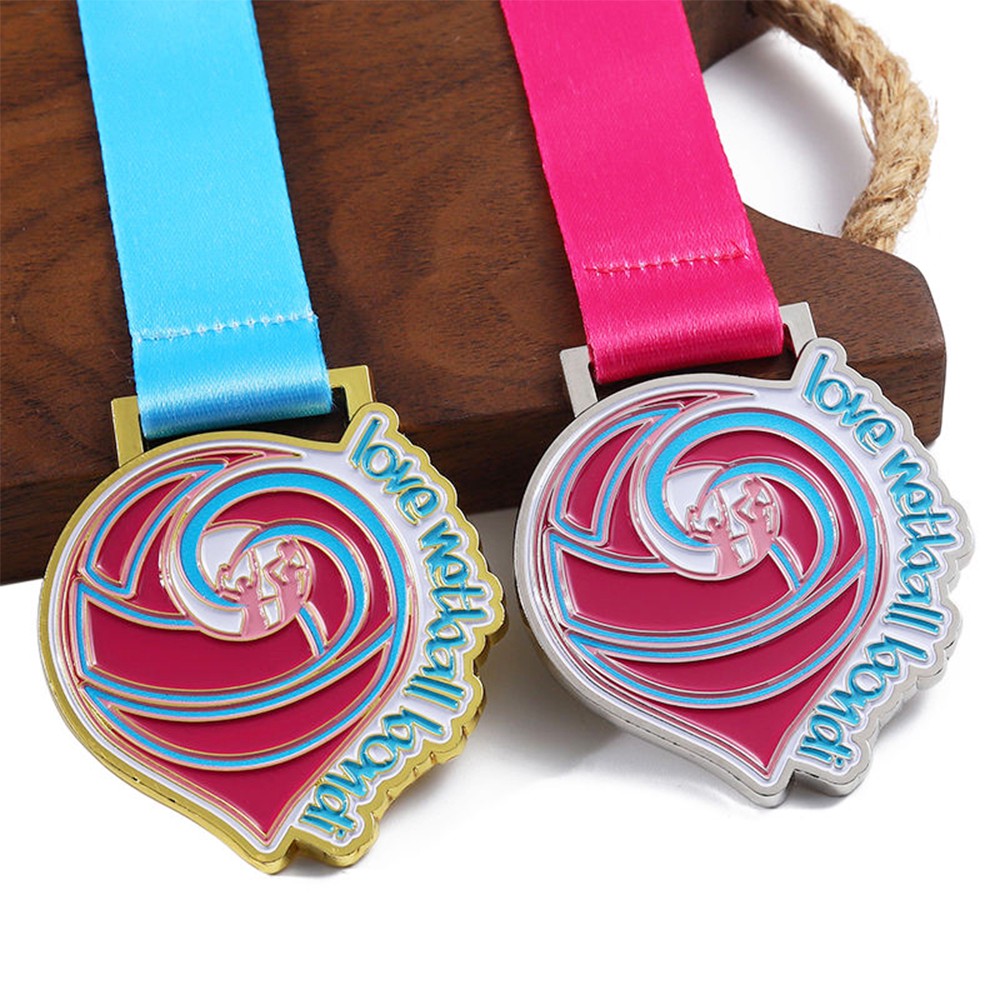 Basketball tournament medals, gold and silver heart-shaped medals of honor.