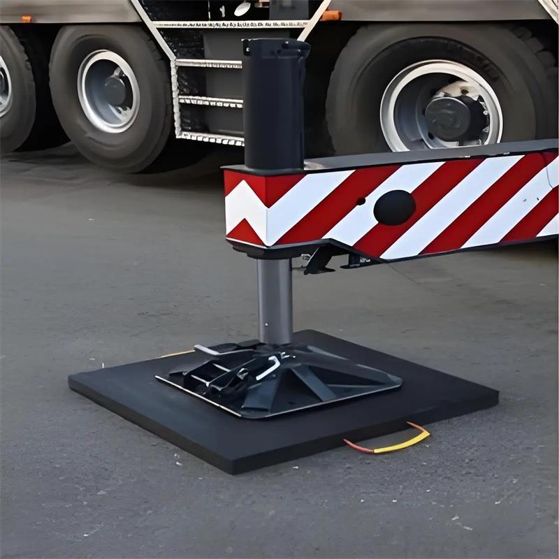 Why are high-molecular-weight polyethylene (PE) materials commonly used for outrigger pads on modern cranes?