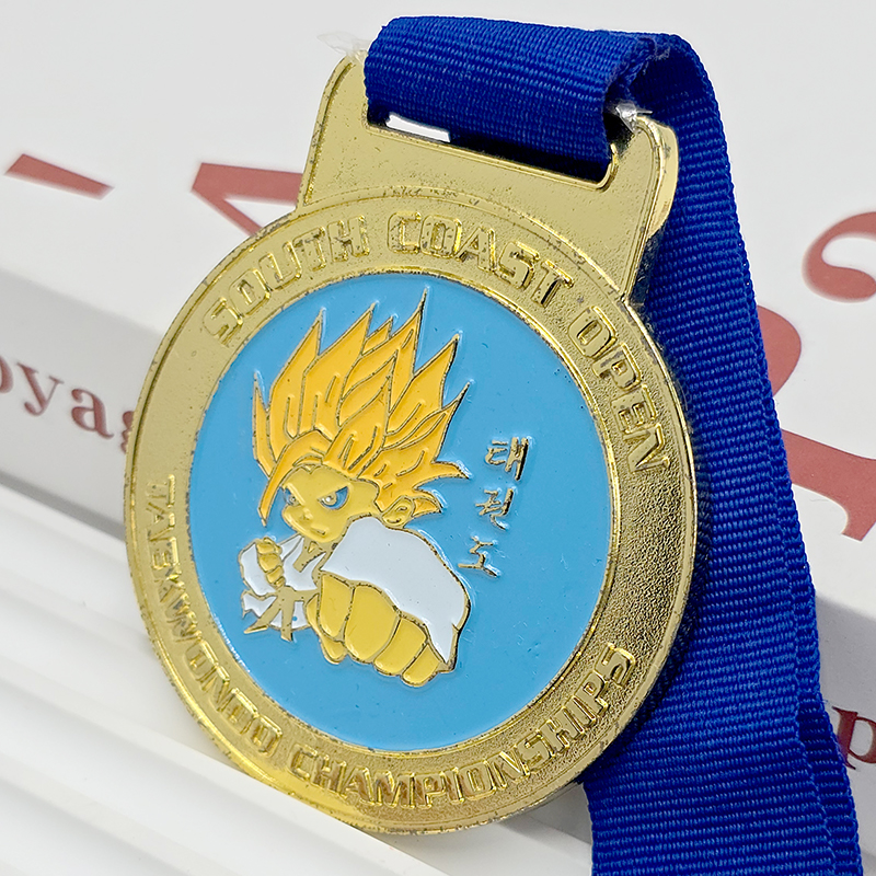 Gold and blue contrasting metallic medal South Coast Open Taekwondo Championship commemorative Super Saiyan cartoon relief anime-themed event collectible.