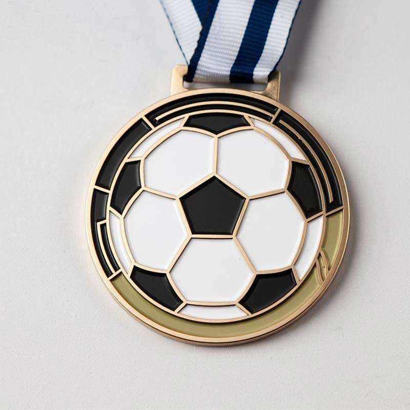 Goldene Fußballspiel-Medaille; schwarz-weiße, fußballförmige Metall-Ehrenmedaille mit Emaille.