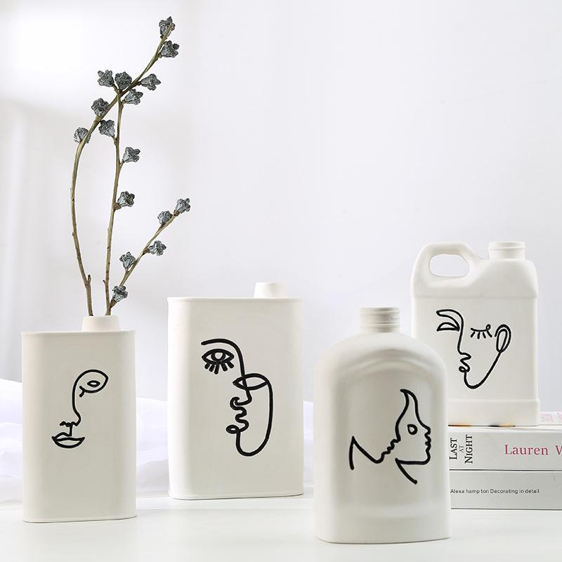 Abstract human face fired ceramic vase