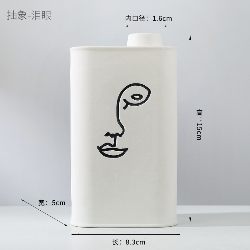 Abstract human face fired ceramic vase