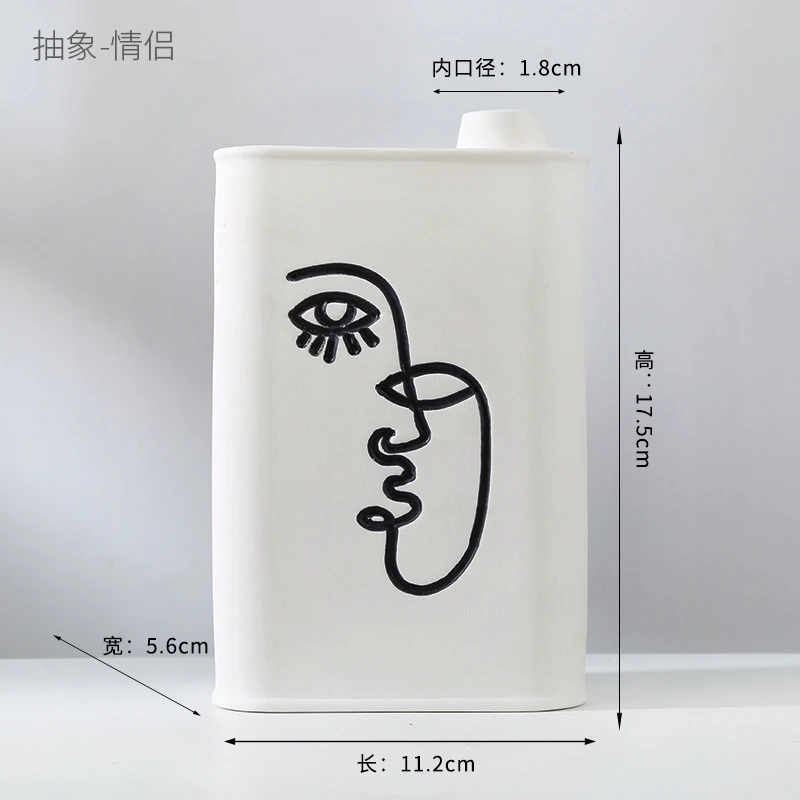 Abstract human face fired ceramic vase