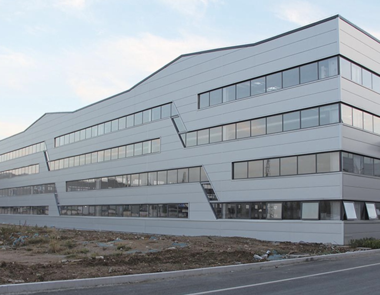 Streamlined modern industrial plant with colored steel cladding