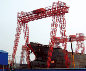 The factory produces portal cranes for port use, specifically for unloading heavy loads4