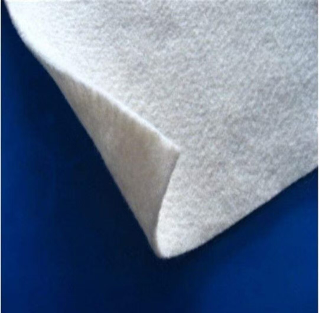 Short fiber needle punched nonwoven geotextile
