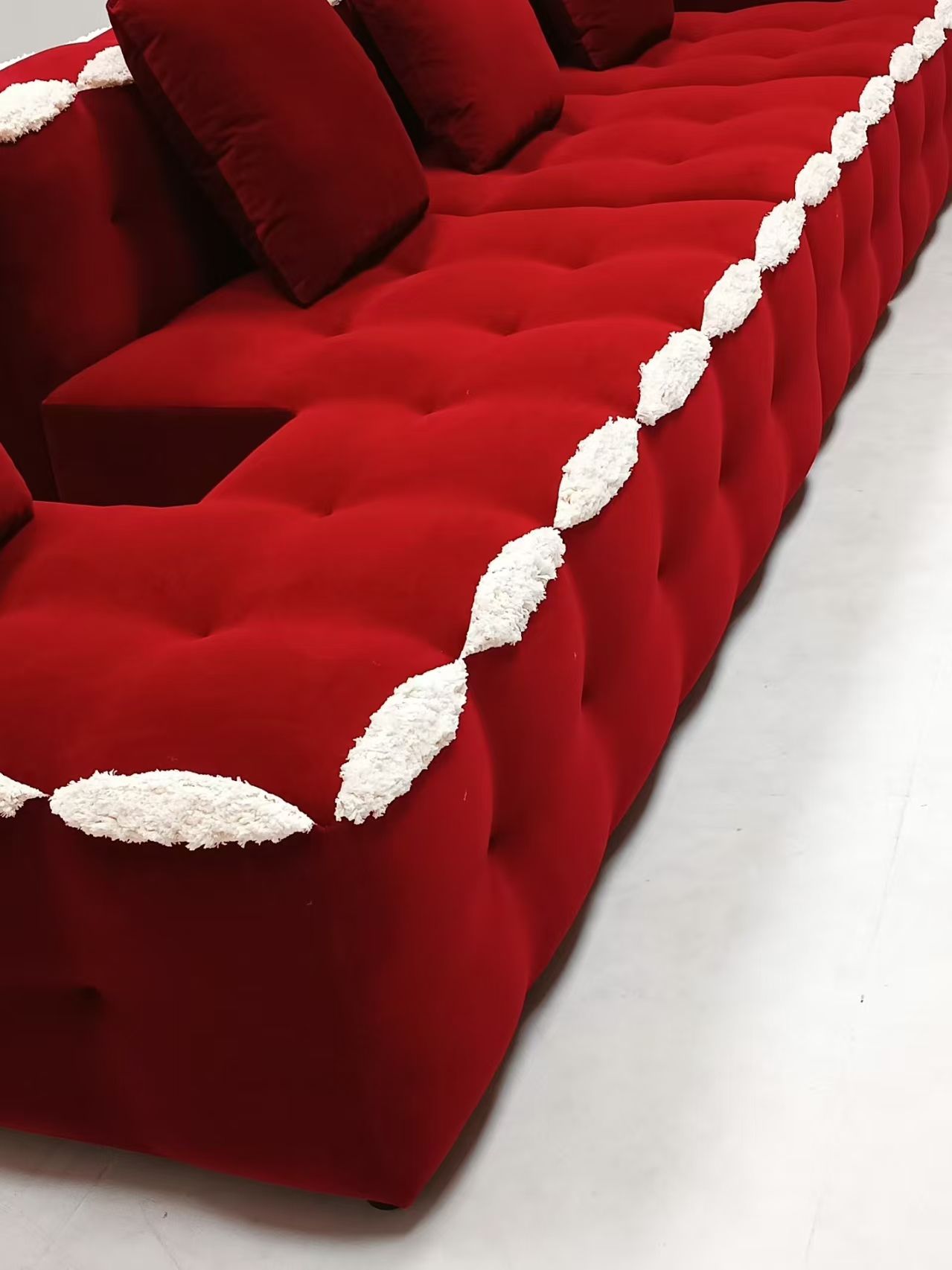 Red velvet L-shaped modern tufted sofa set with white accents, made of microfiber fabric and sponge filling, suitable for living rooms, hotels, and apartments.