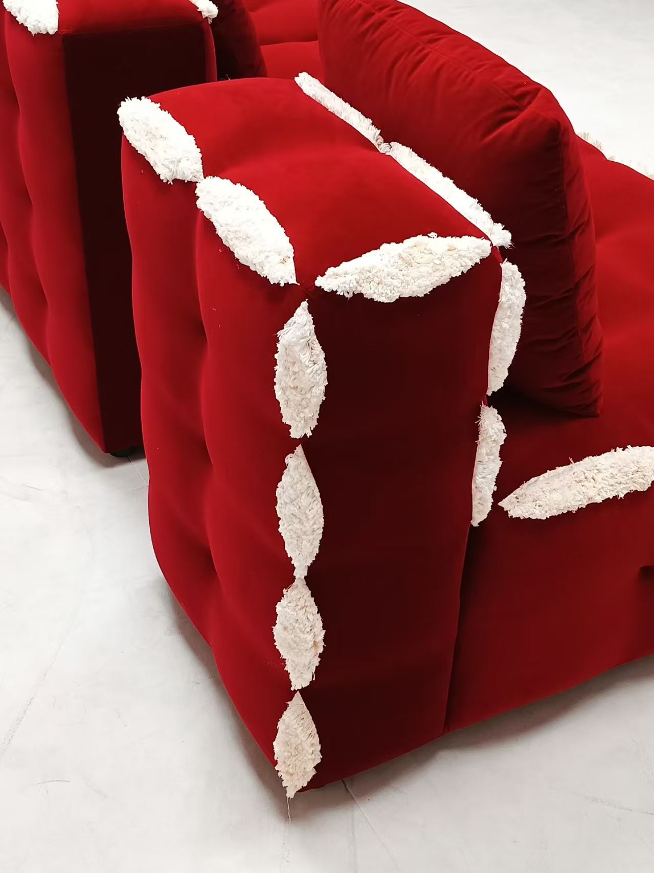 Red velvet L-shaped modern tufted sofa set with white accents, made of microfiber fabric and sponge filling, suitable for living rooms, hotels, and apartments.