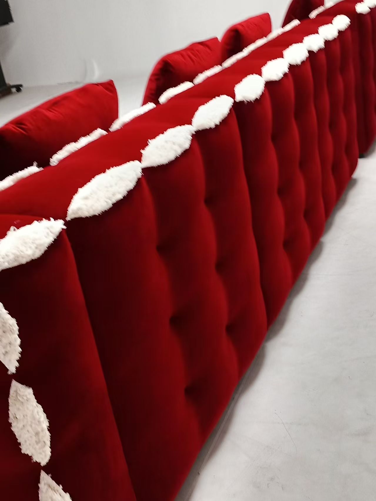Red velvet L-shaped modern tufted sofa set with white accents, made of microfiber fabric and sponge filling, suitable for living rooms, hotels, and apartments.