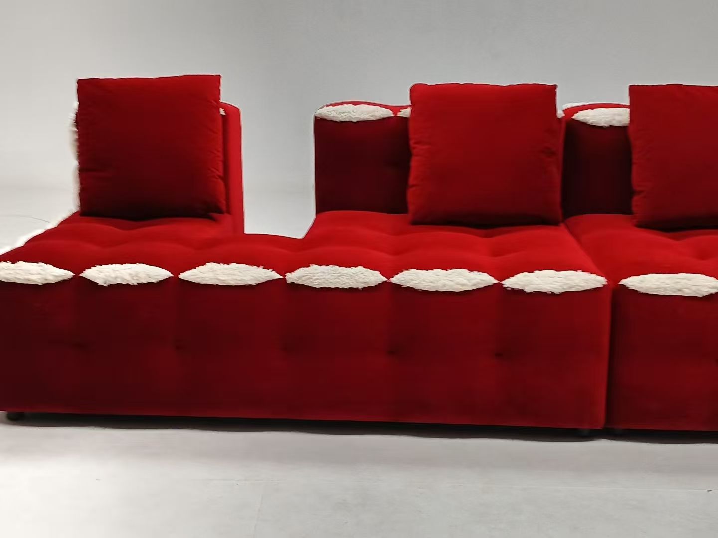 Red velvet L-shaped modern tufted sofa set with white accents, made of microfiber fabric and sponge filling, suitable for living rooms, hotels, and apartments.