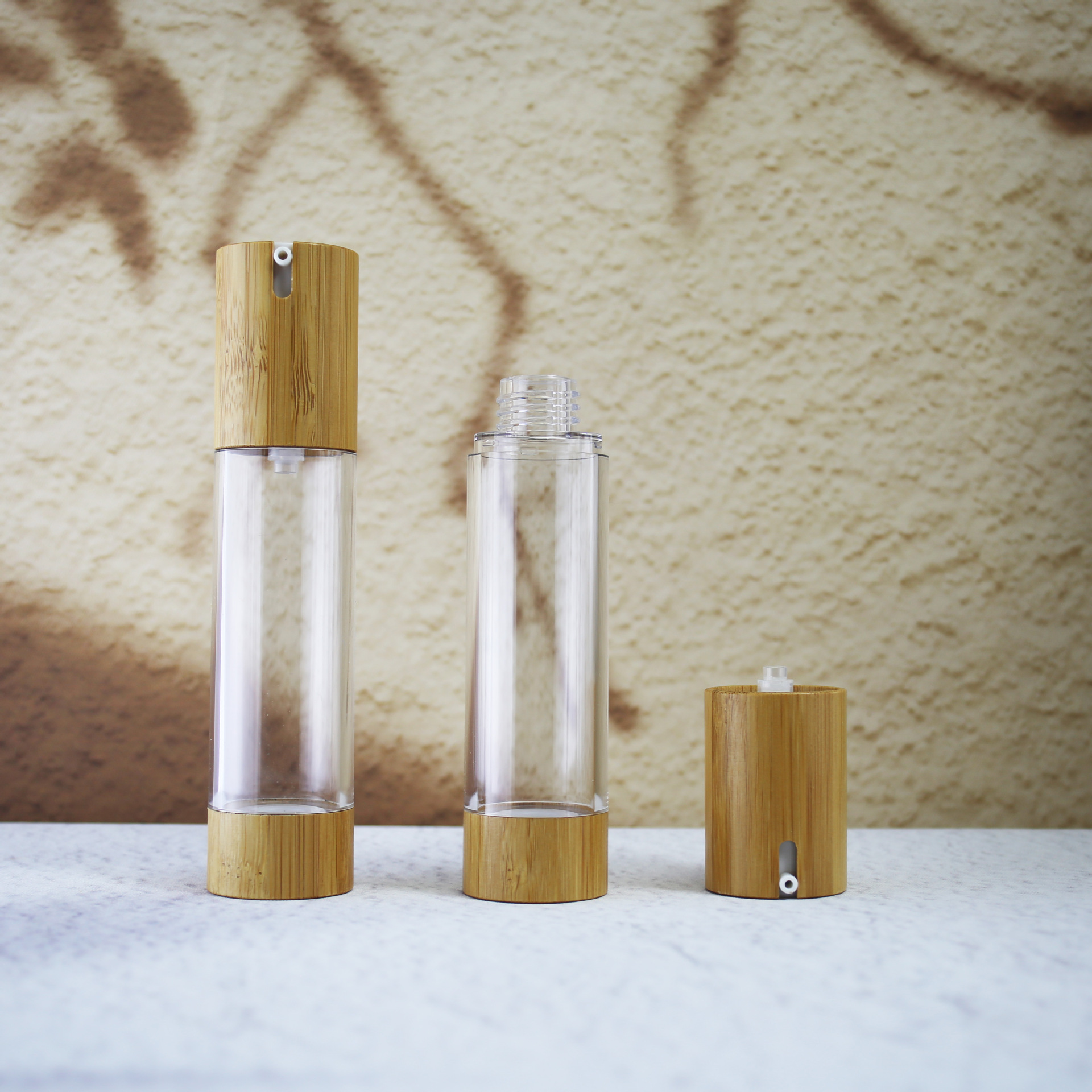 Luxury Wholesale Bamboo Empty PET Lotion Pump Bottle 50ml Essential Oil Perfume Plastic Airless Pump Bottle