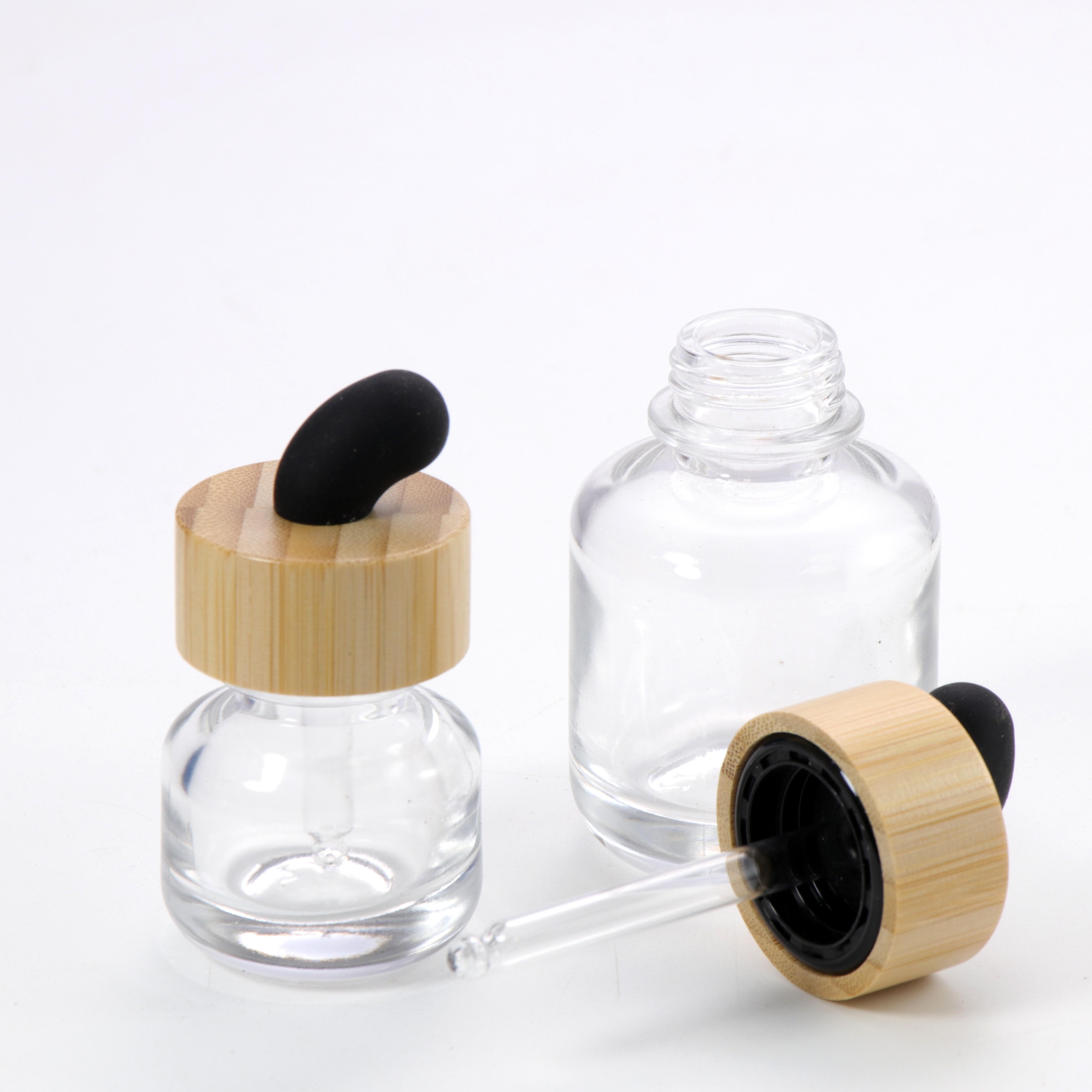 New Product Essential Oil Bottle Eco Friendly Clear Glass Dropper Packaging with Natural Bamboo Ring Cap for Face Serum Hair Oil