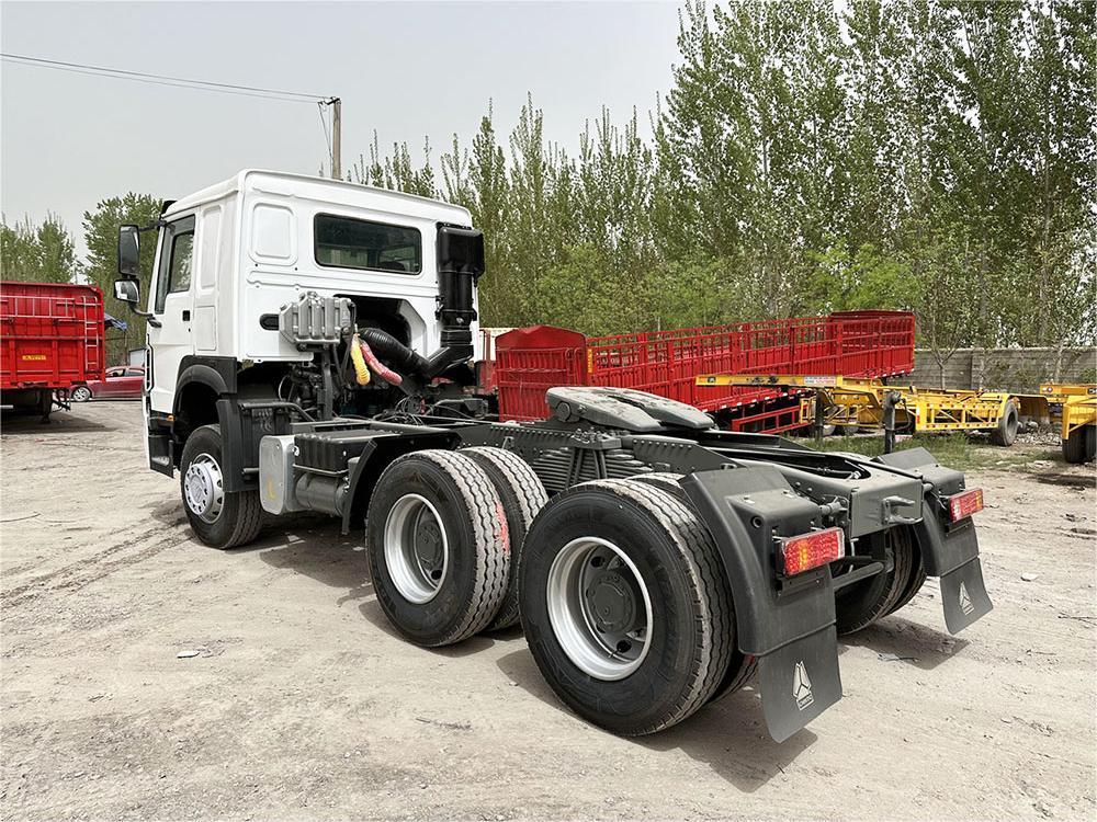 HOWO 371HP 6x4 Tractor Truck rear 3/4 view showing heavy-duty chassis, fifth wheel, and cargo coupling
