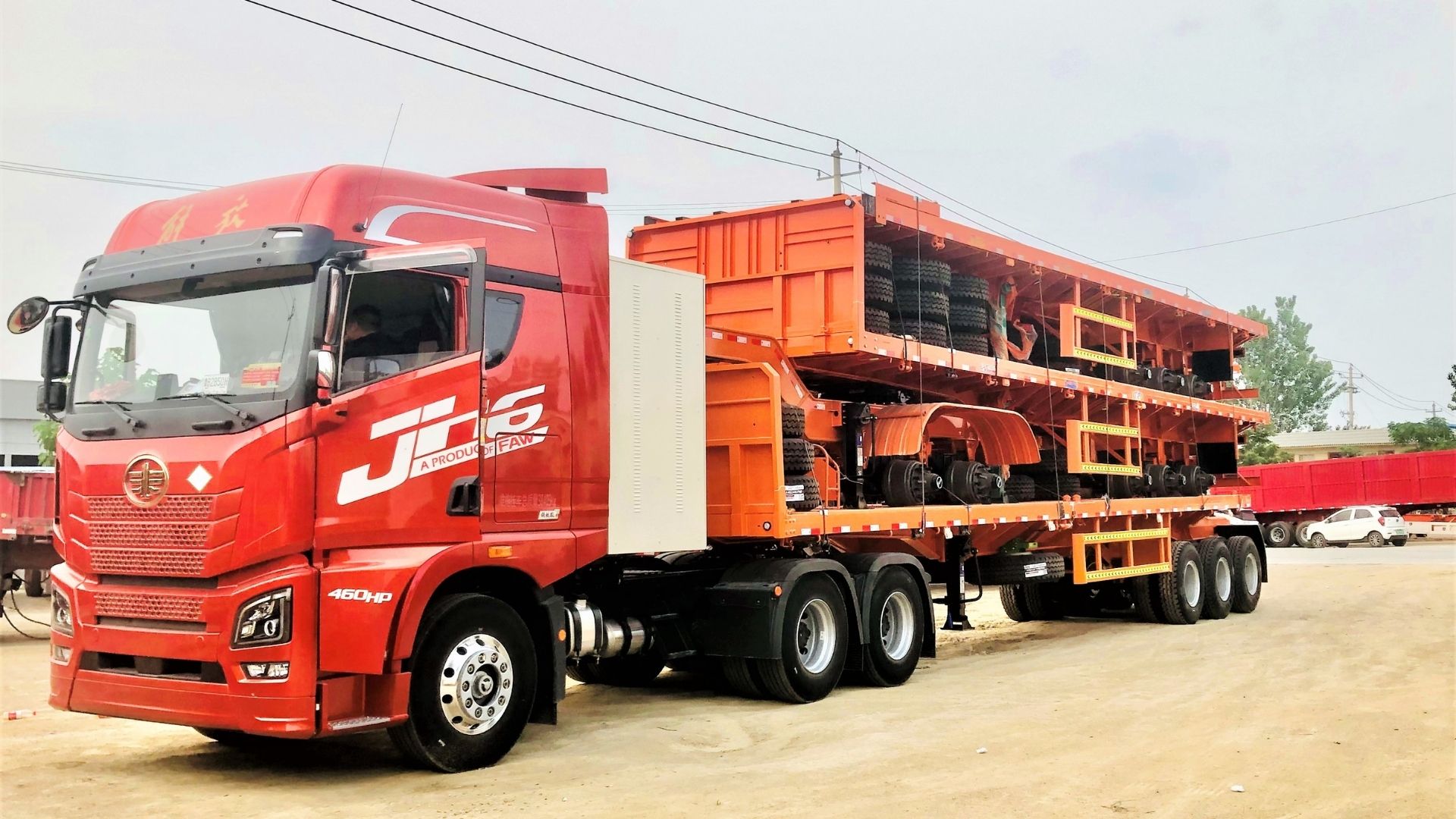 ZW Group flatbed semi trailer factory dispatch: professional packaging and secure loading of high-quality trailers for global export.