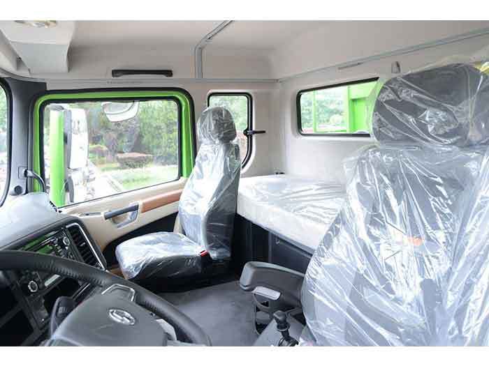 Shacman X5000 8x4 heavy duty dump truck cabin interior showing premium materials and ergonomic layout