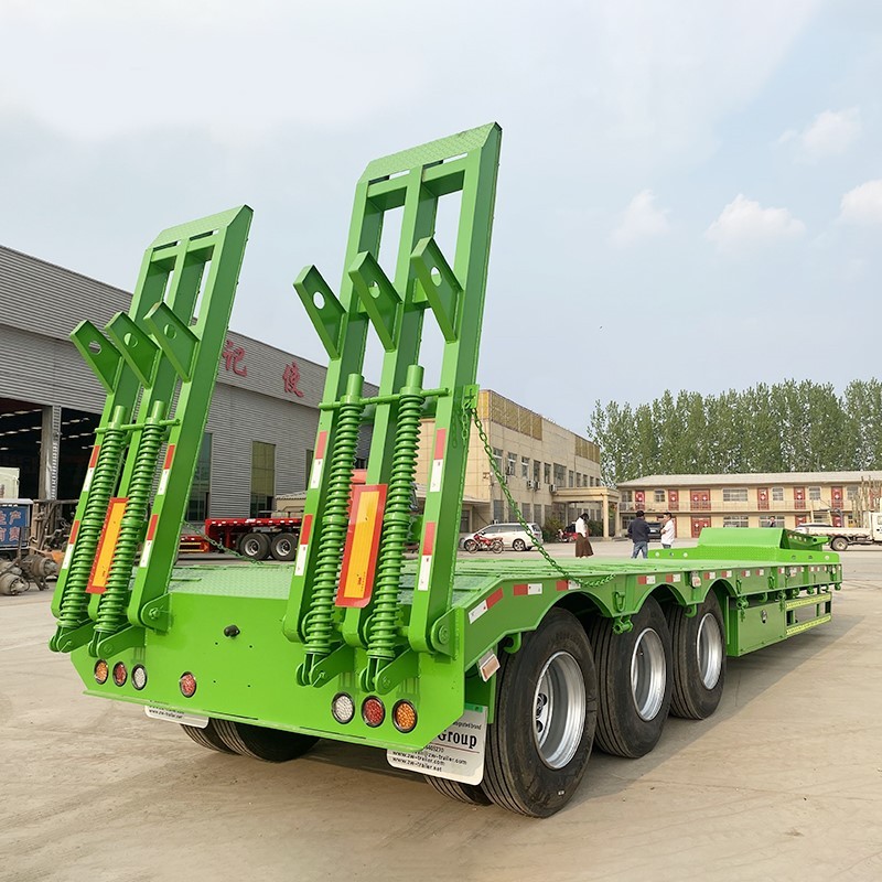3 axle 60 ton lowbed semi trailer rear three quarter view showing heavy duty ramps and rear frame