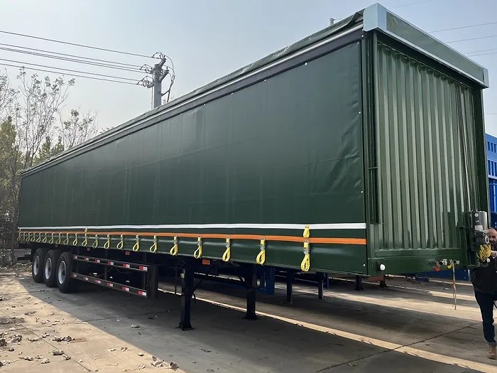 3 axle curtain cargo trailer front three quarter view highlighting curtain side system and chassis